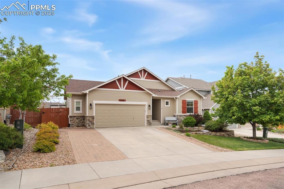 Craftsman inspired home with driveway, a garage, stone siding, and roof with shingles