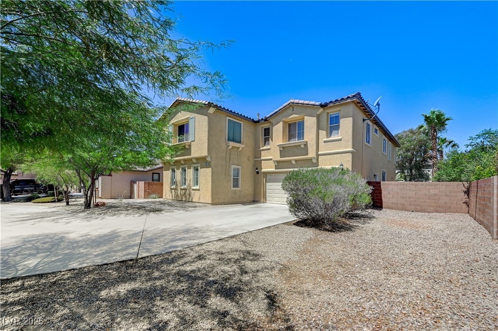 Rear view of property with a garage, stucco siding