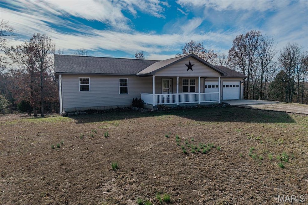 Single story home featuring a porch, roof with shingles, concrete driveway, and a garage