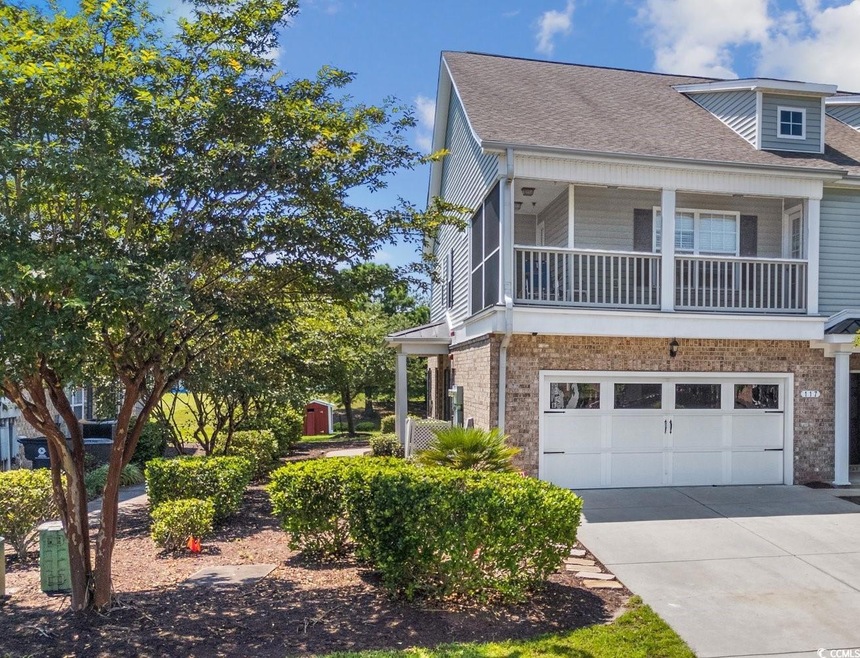 View of side of property with a garage