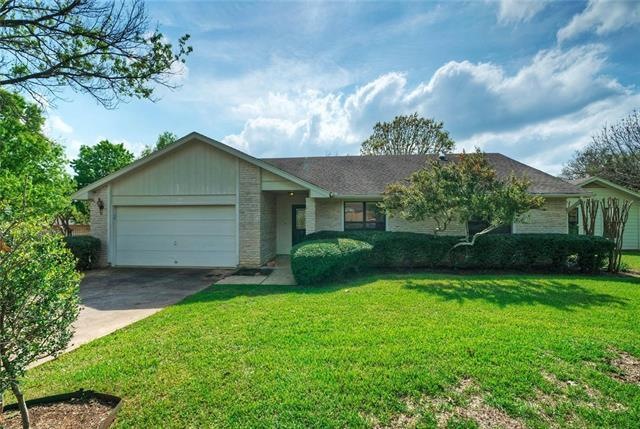 This Georgetown home shows off plenty of attractive landscaping, including a lush front lawn.