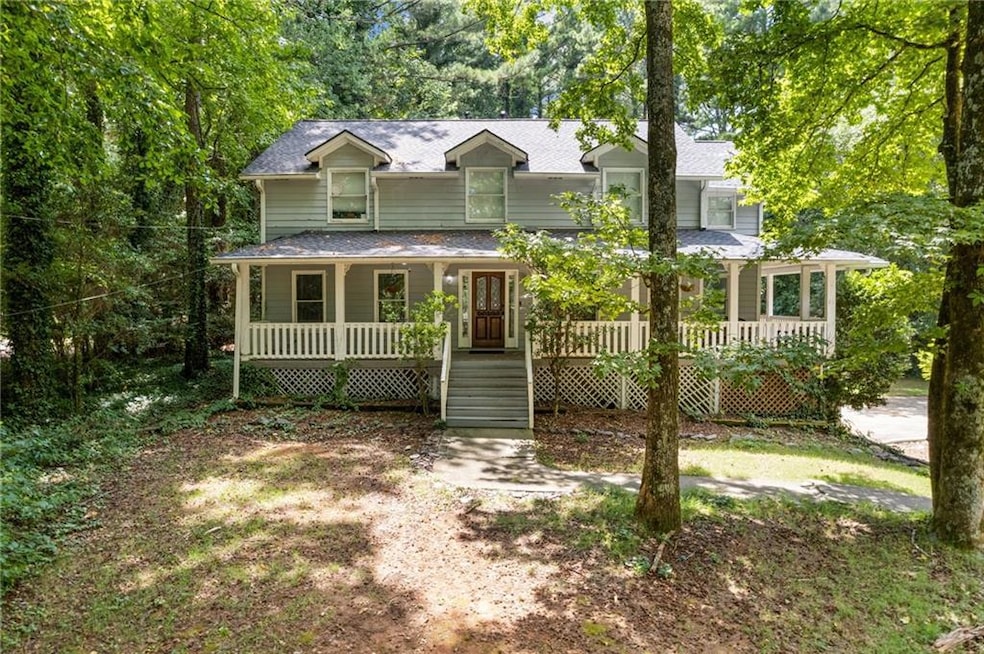 View of front of property featuring a porch and a shingled roof