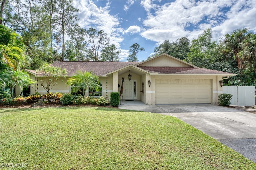 Ranch-style home featuring a front lawn and a gara