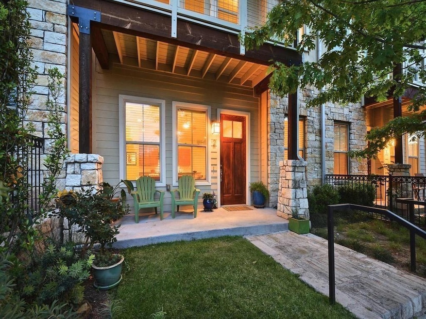 Rear view of property with a porch and stone sidi
