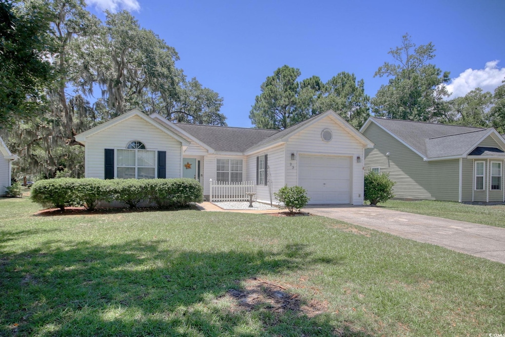 Ranch-style house featuring an attached garage, driveway, and a front lawn