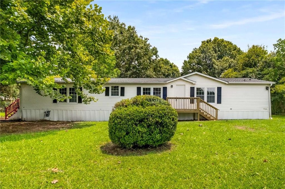 Back of house with a yard and a deck