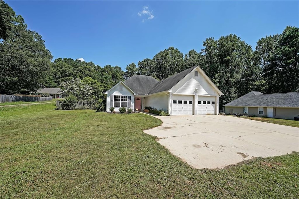 Single story home featuring an attached garage and driveway