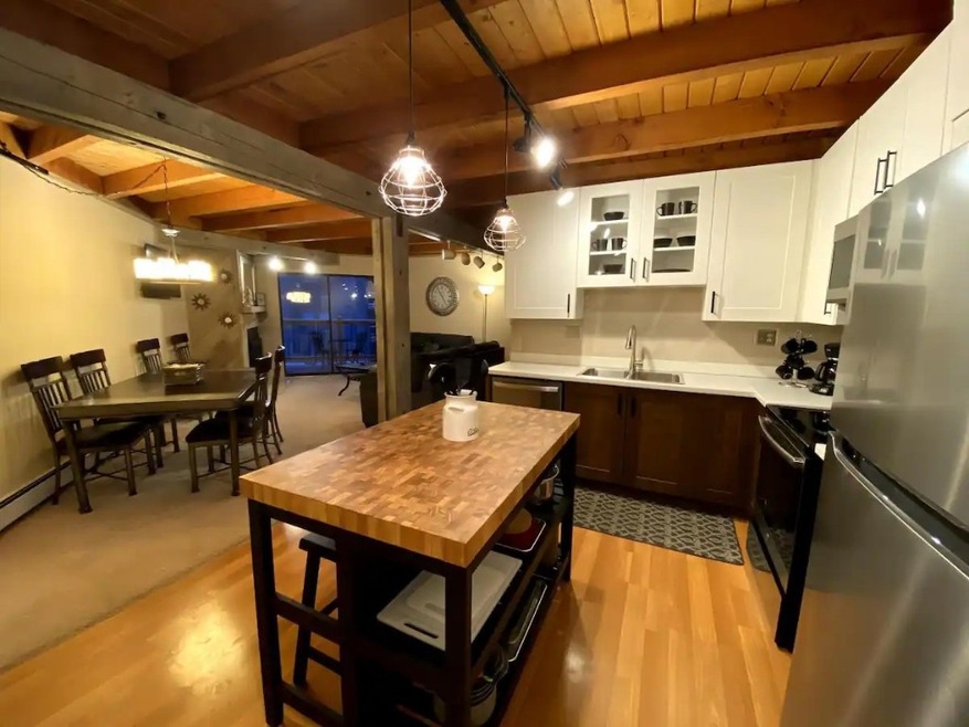 Kitchen featuring beam ceiling, wooden ceiling, st