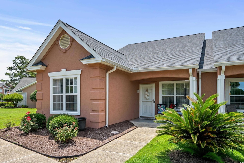 View of front of home featuring a shingled roof and stucco siding