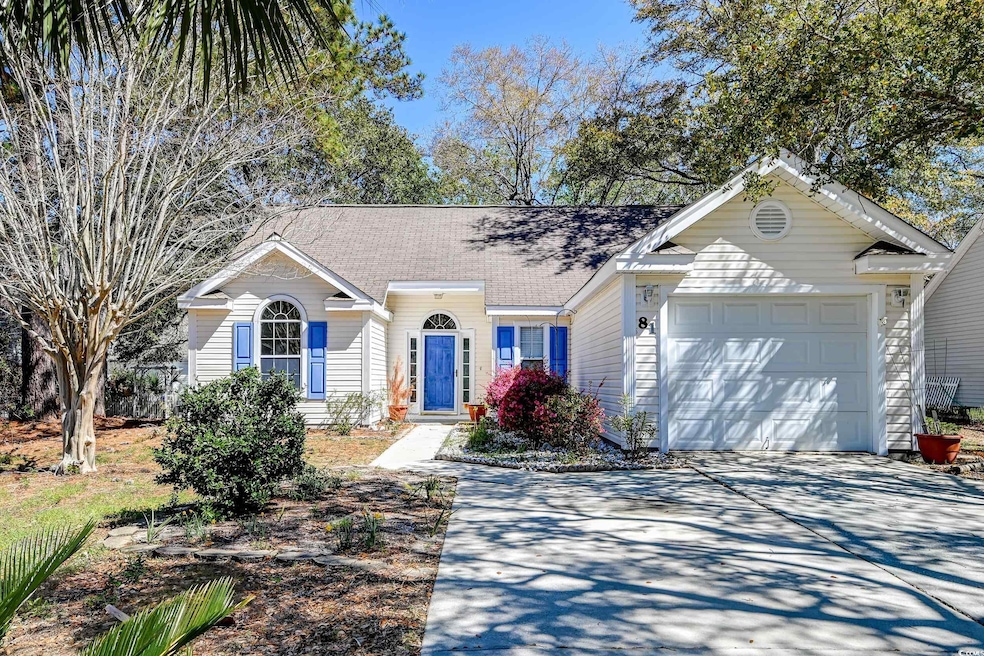 Ranch-style home with roof with shingles, a garage