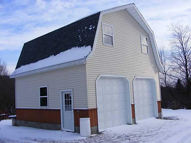 Exterior Front. man door side of garage built new 