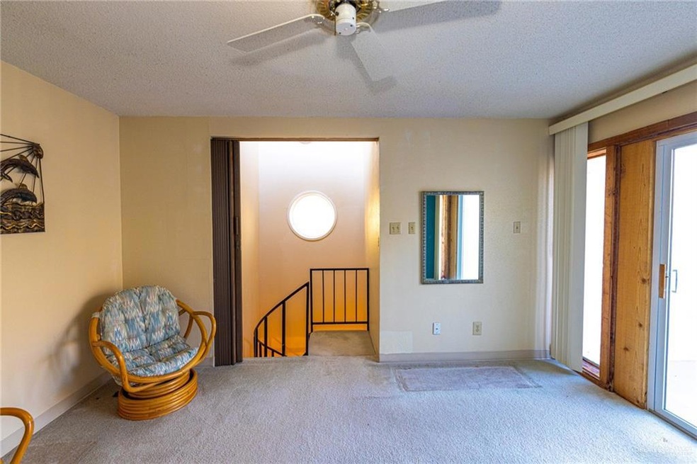 Unfurnished room with a textured ceiling, ceiling fan, plenty of natural light, and light colored carpet