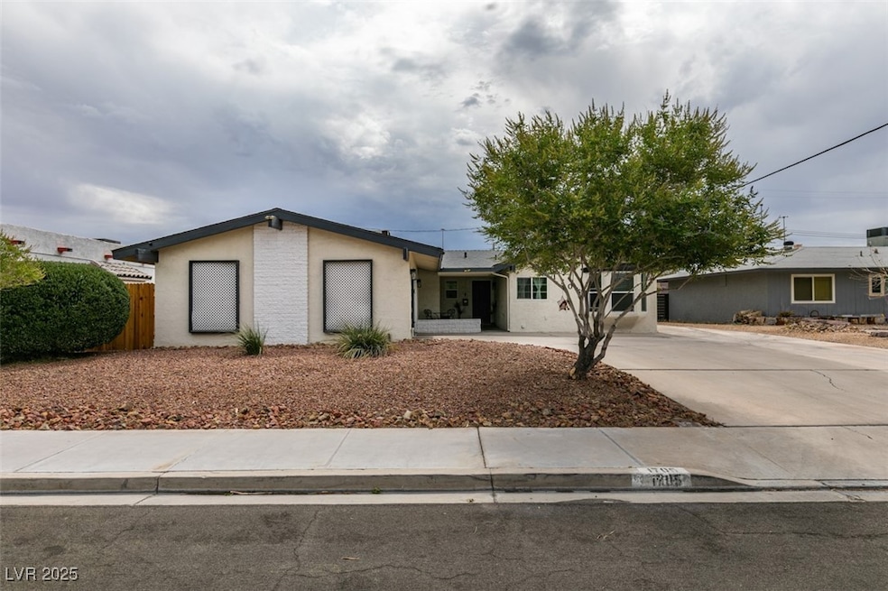 View of front of house featuring driveway and stucco siding