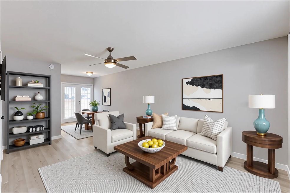 Living area with light wood finished floors, a ce