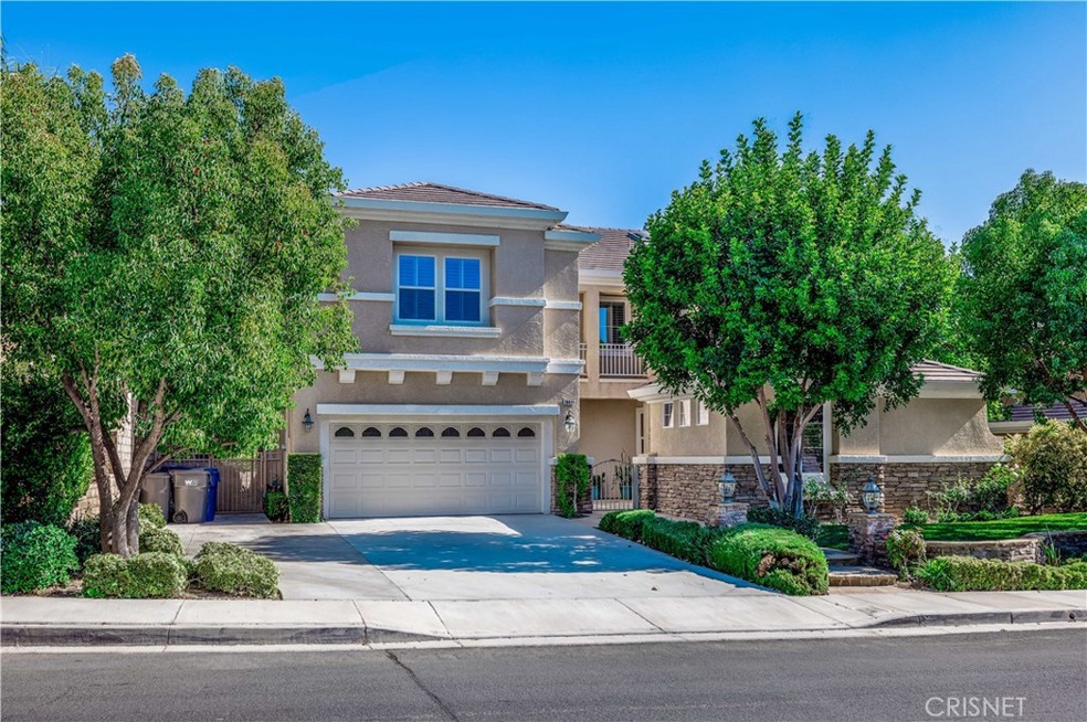 Front of home with large driveway.