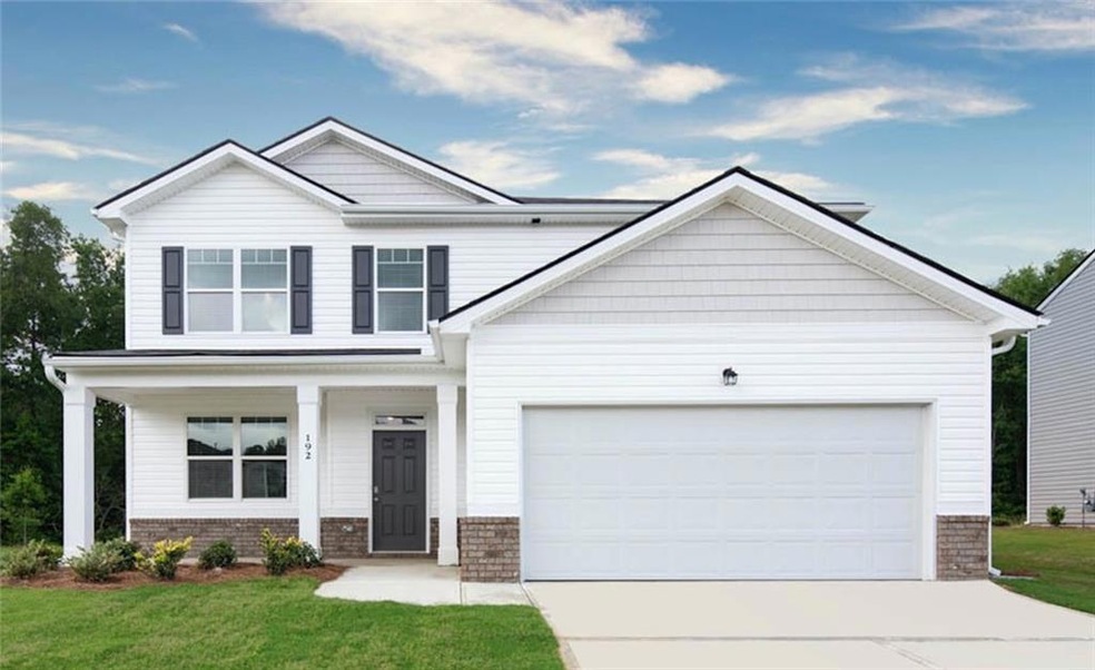 View of front of house with a front yard, a garage