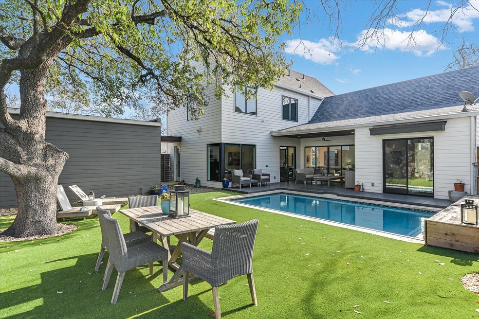 Rear view of house featuring an outdoor pool, a l