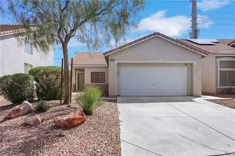 Ranch-style house with stucco siding, a tiled roof