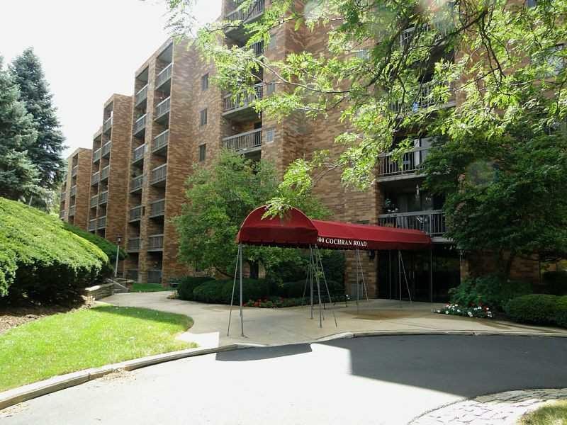 Exterior Front. Security building with pool, libra
