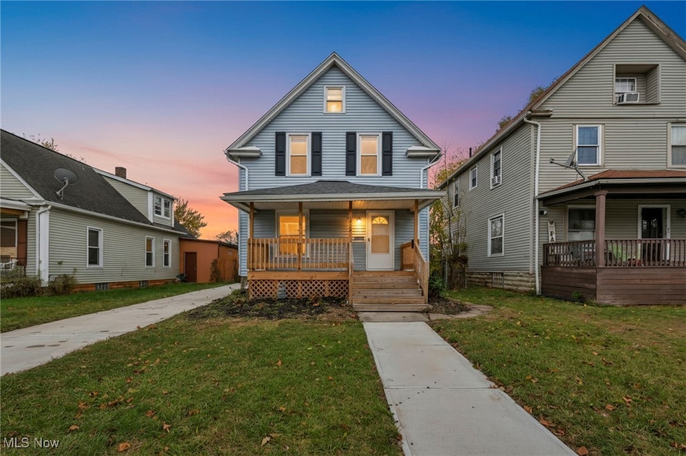 View of front facade featuring a porch and a yard