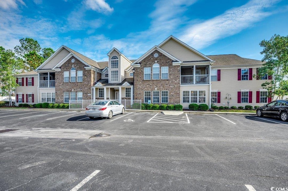 View of property with uncovered parking