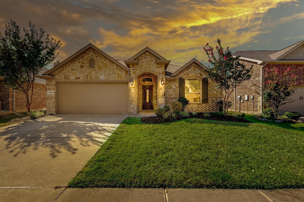 View of front of house with a yard and a garage