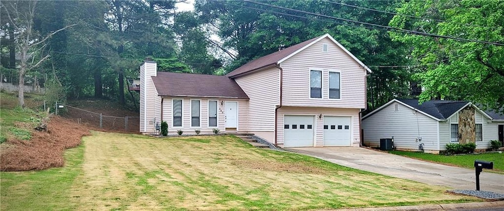 Tri-level home with a chimney, fence, an attached 
