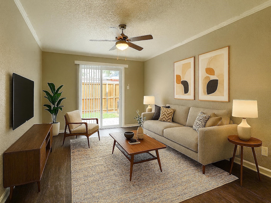 Living room featuring a textured ceiling, crown molding, dark wood-style flooring, a ceiling fan, and a textured wall