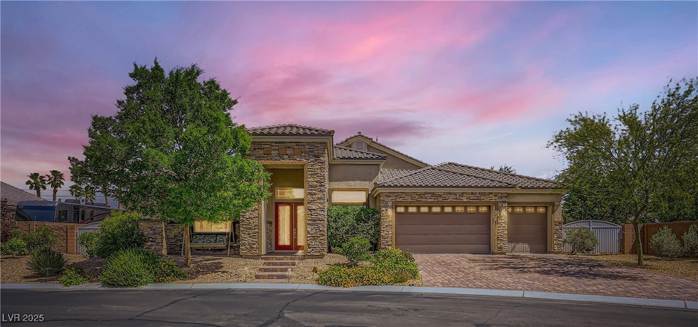View of front of house with stone siding, an attac