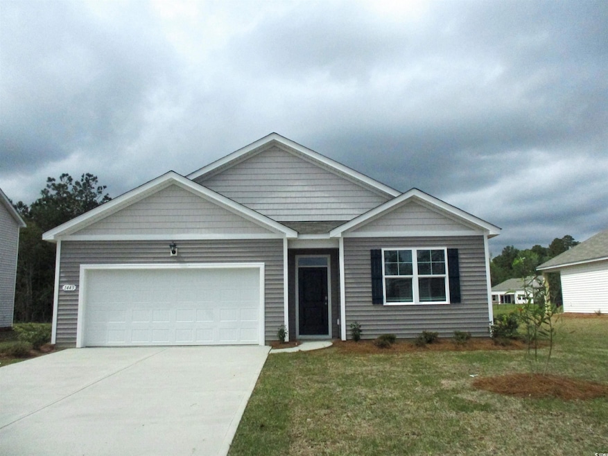 View of front of house with concrete driveway, a front yard, and a garage