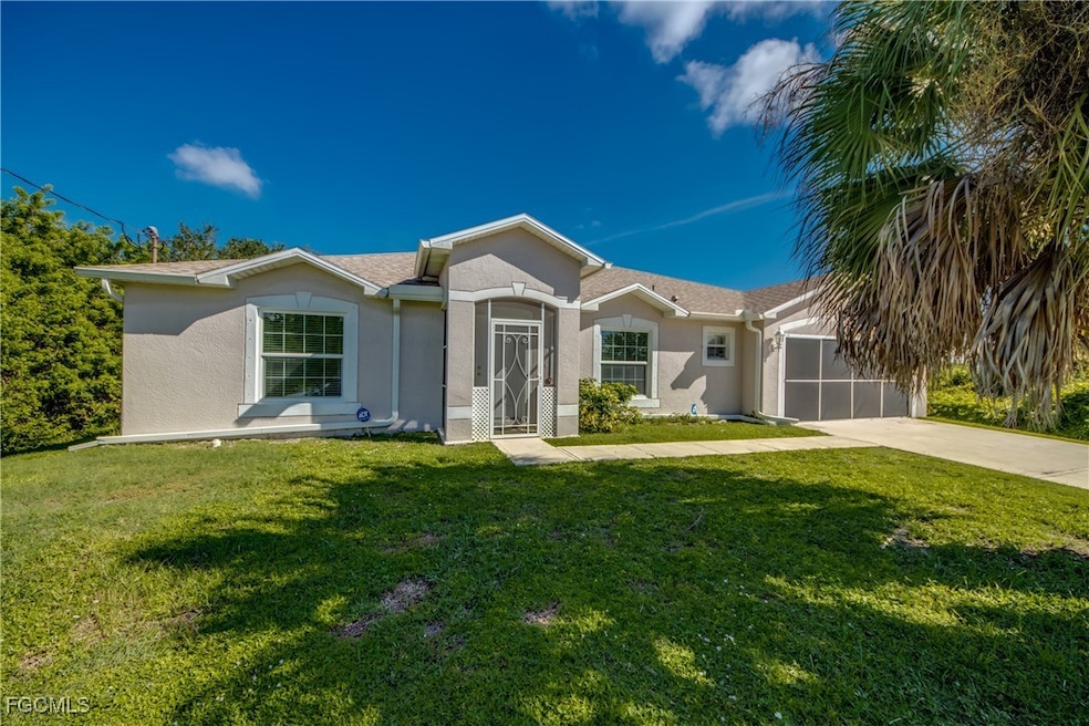 Ranch-style house featuring stucco siding, a front lawn, driveway, and a garage