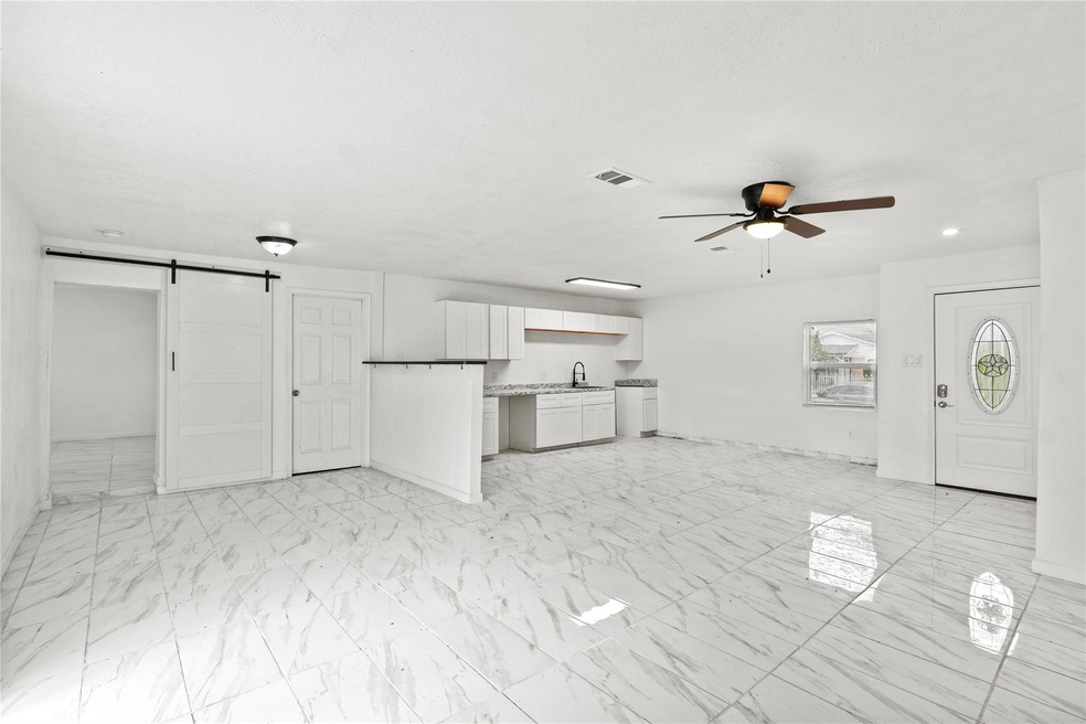 Unfurnished living room with a barn door, ceiling 