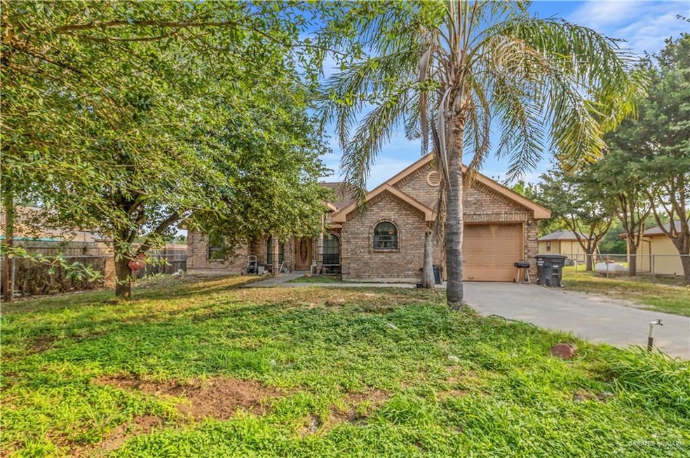 View of front of home featuring a garage and a front yard