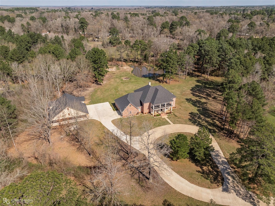Aerial view featuring a wooded view