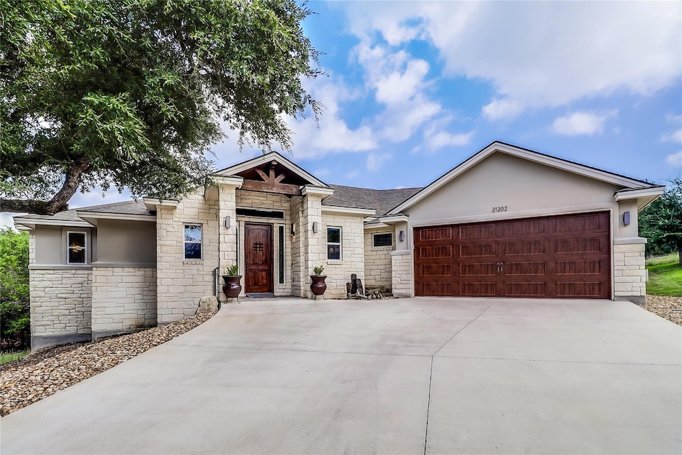 View of front of home with stone siding, stucco s