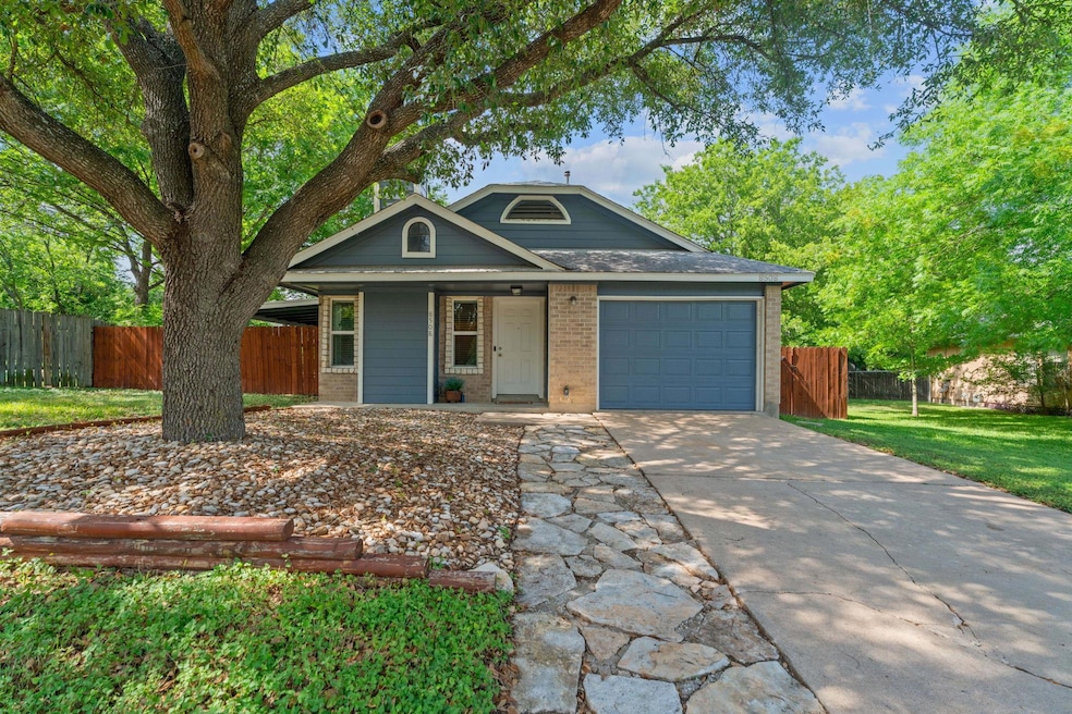 View of front of house with a garage, brick sidin