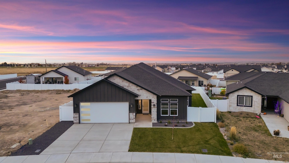 View of front facade with stone siding, board and batten siding, driveway, and an attached garage