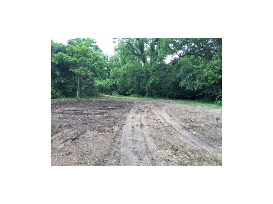 Level lot in heart of Shawnee is surrounded by tre