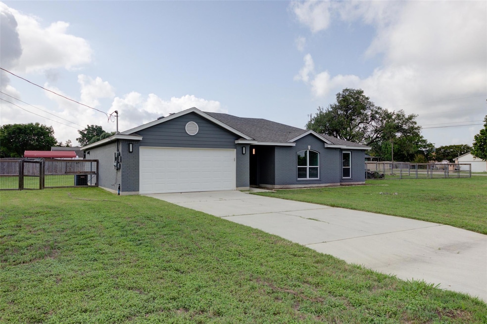 Single story home featuring brick siding, a garag
