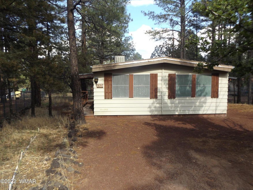 Front of Home surrounded by Tall Pines