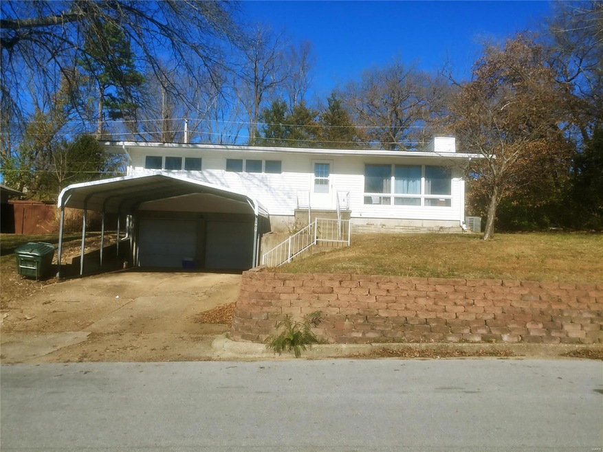 Raised ranch style home w/2 car garage tucked unde