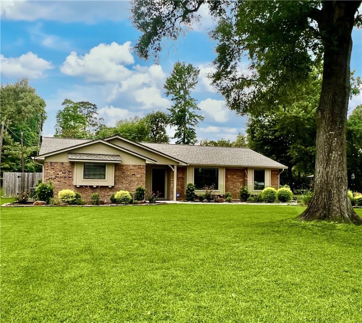 Ranch-style house with brick siding