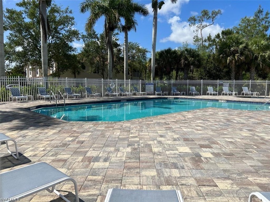 Community pool with fence and a patio