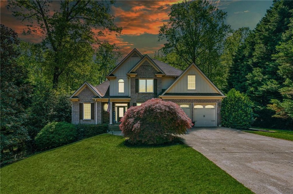 View of front of home with a front lawn, board and