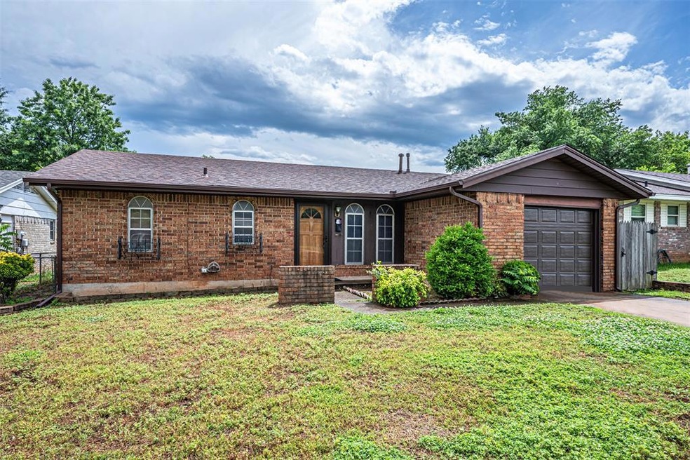Single story home featuring a front lawn and a gar
