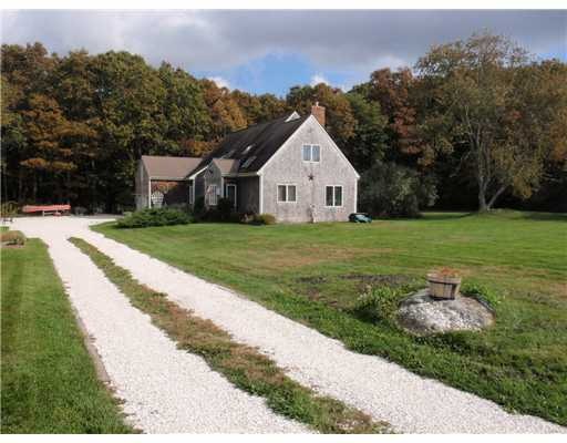 Exterior Front. A crushed sea shell driveway leads
