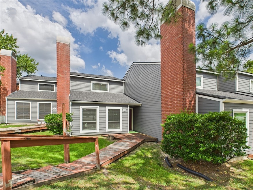 Rear view of property with a lawn and a chimney