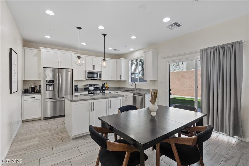 Kitchen featuring stainless steel appliances, whit