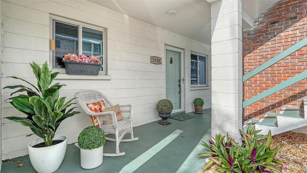 Covered porch, brick exterior, and charming entryway.