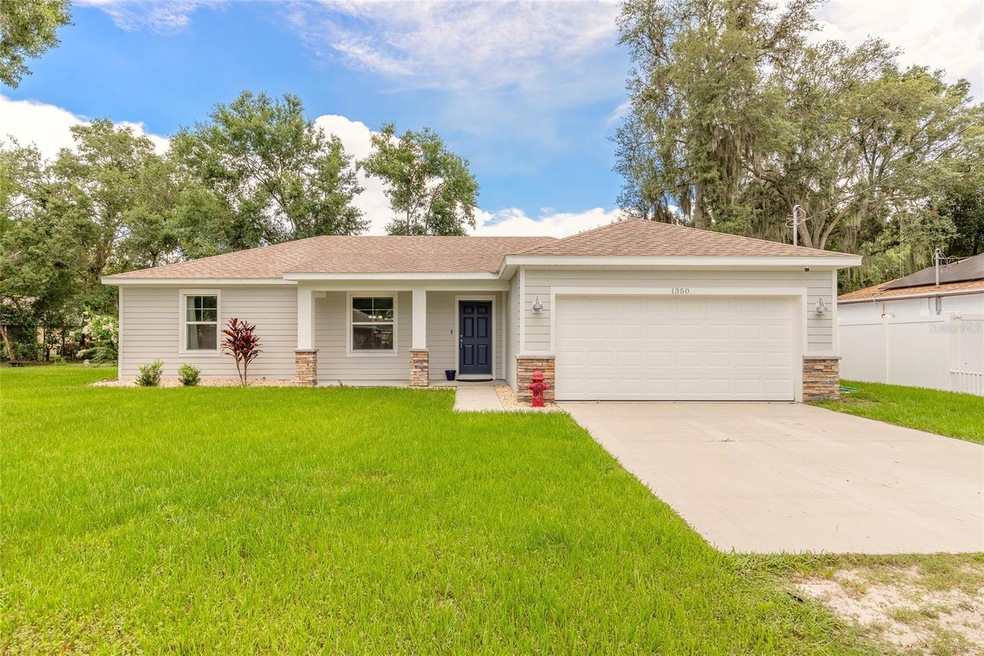 Front elevation view of home; landscaping, front entryway and driveway at 1350 7th Street, Orange City, Florida